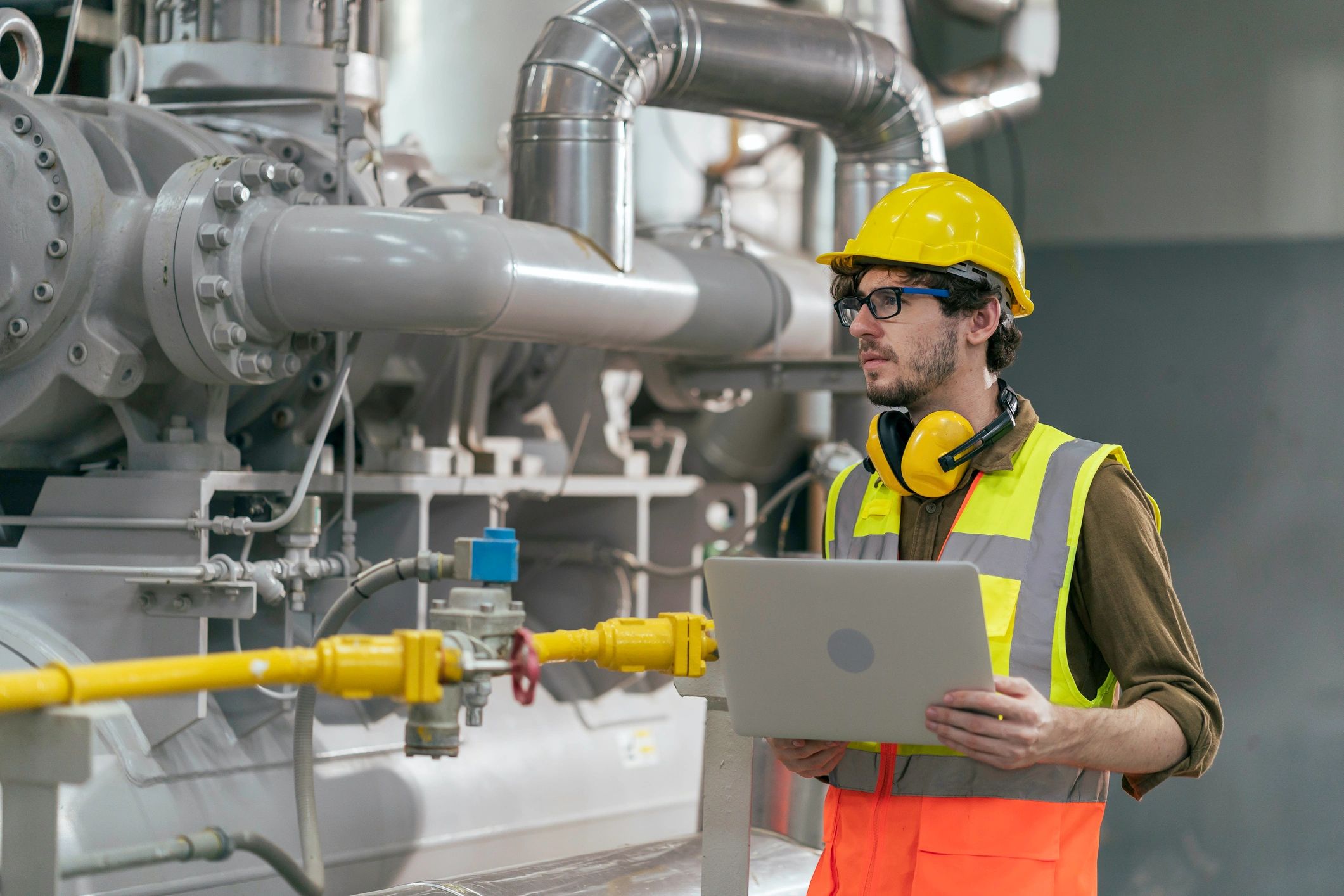 Engineer inspecting equipment in a mechanical room