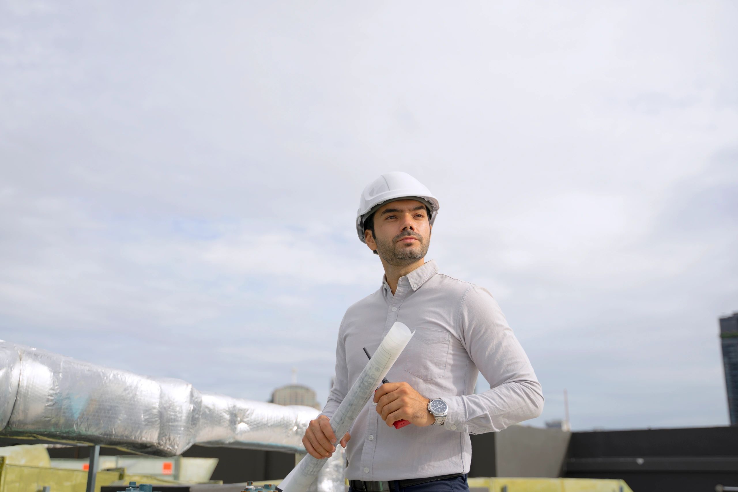 Technician on a rooftop in an urban setting