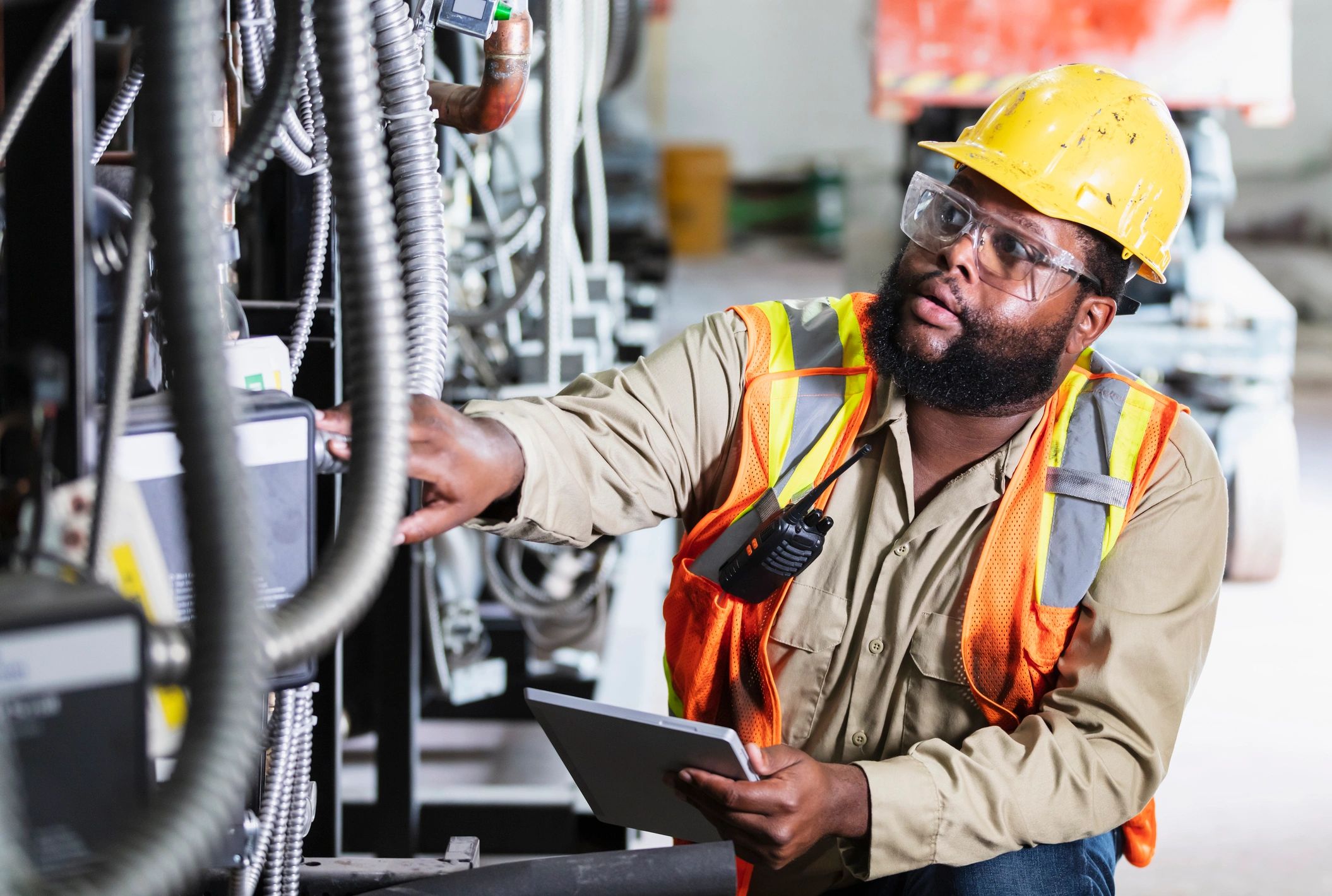 Technician inspecting industrial refrigeration equipment