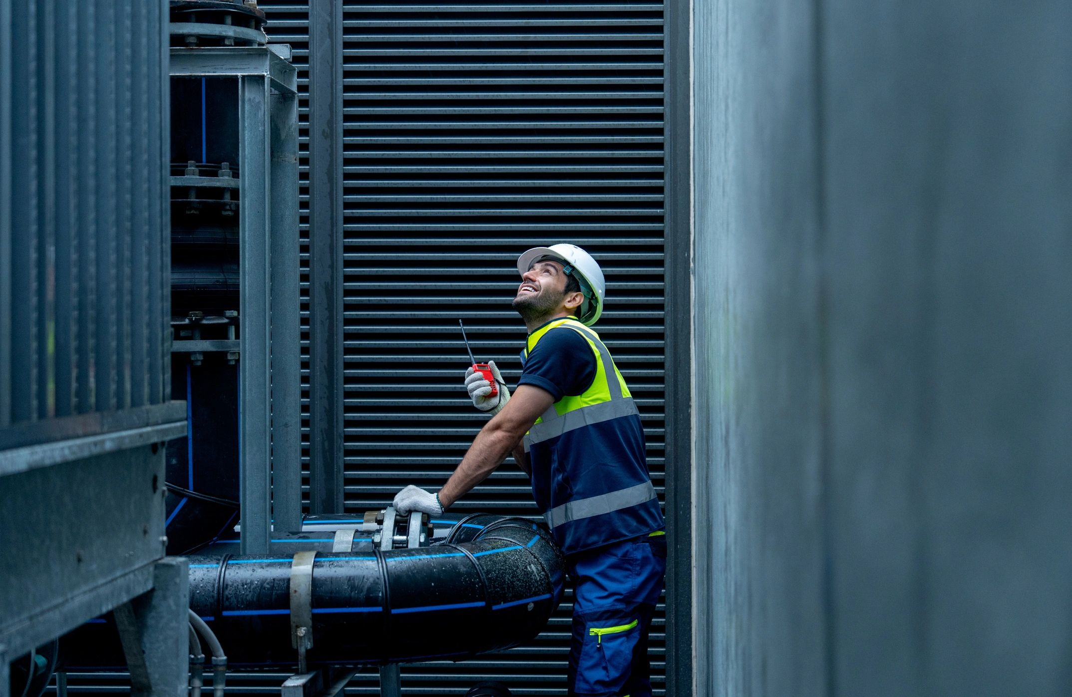 Technician inspecting mechanical equipment in a commercial setting